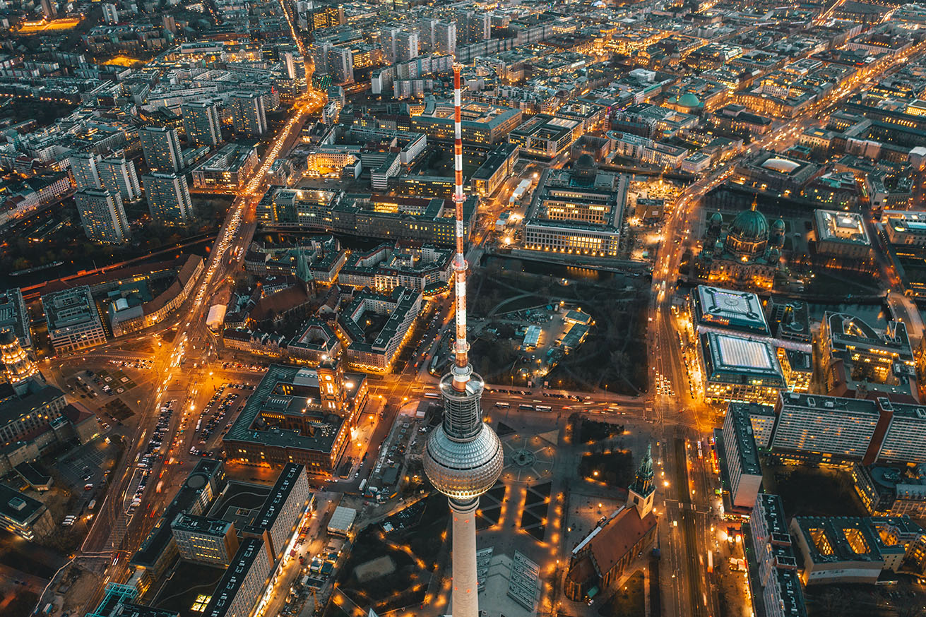 Wide View of Beautiful Berlin, Germany Cityscape after Sunset with lit up Streets and Alexanderplatz TV Tower, Aerial Drone View HQ